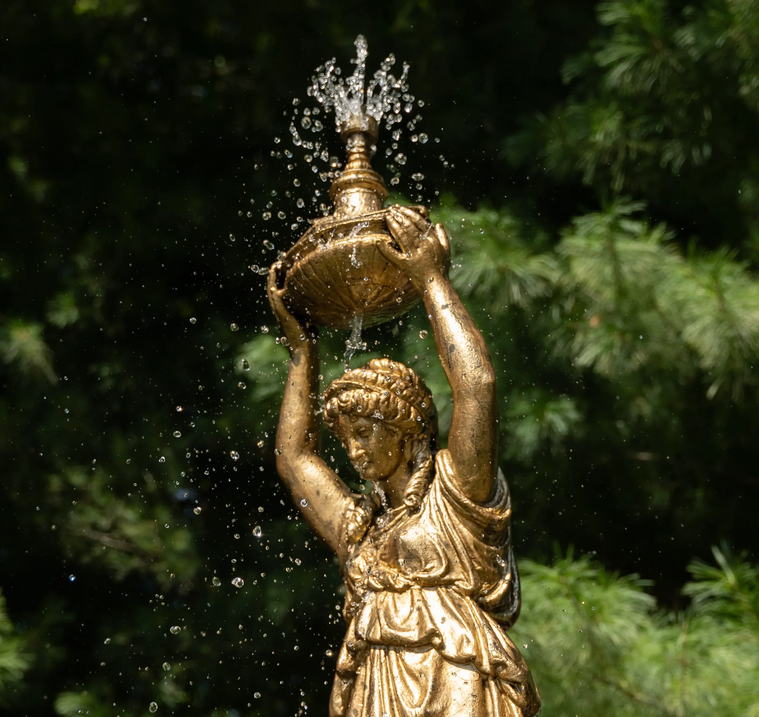 Water droplets and the figure atop the Pleasant View fountain shine in the sun on a late summer day in 2025.
