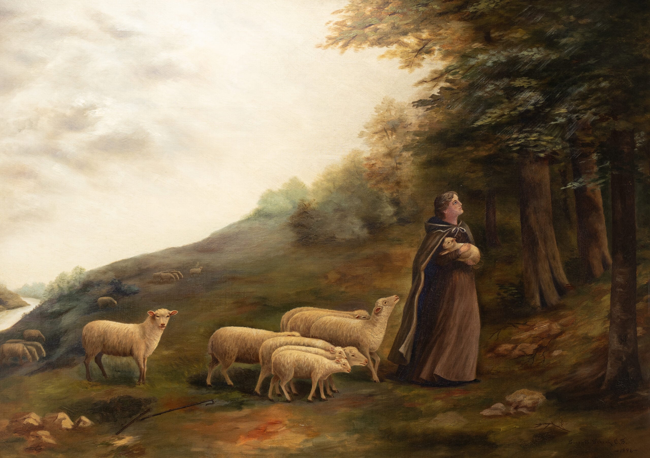 A shepherdess holds a lamb and sheep follow behind as she looks up into the woods on a hillside.