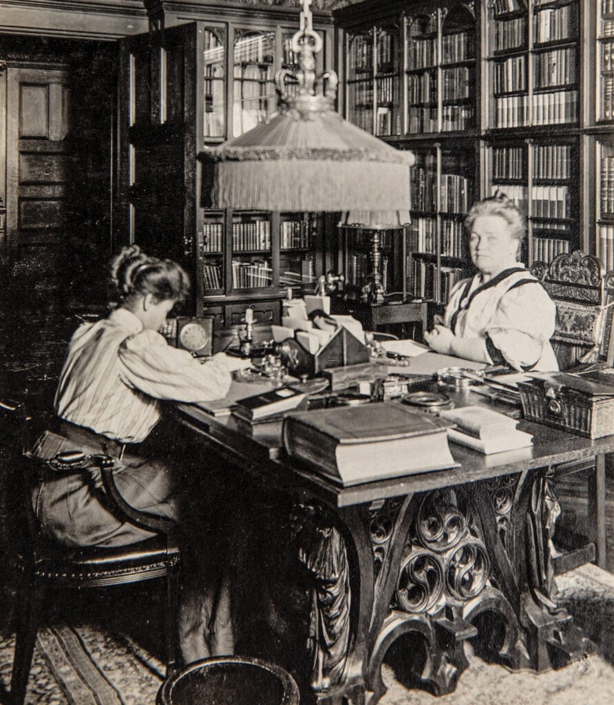 Longyear Museum Collection photo: Mary Beecher Longyear working in her library with an assistant.