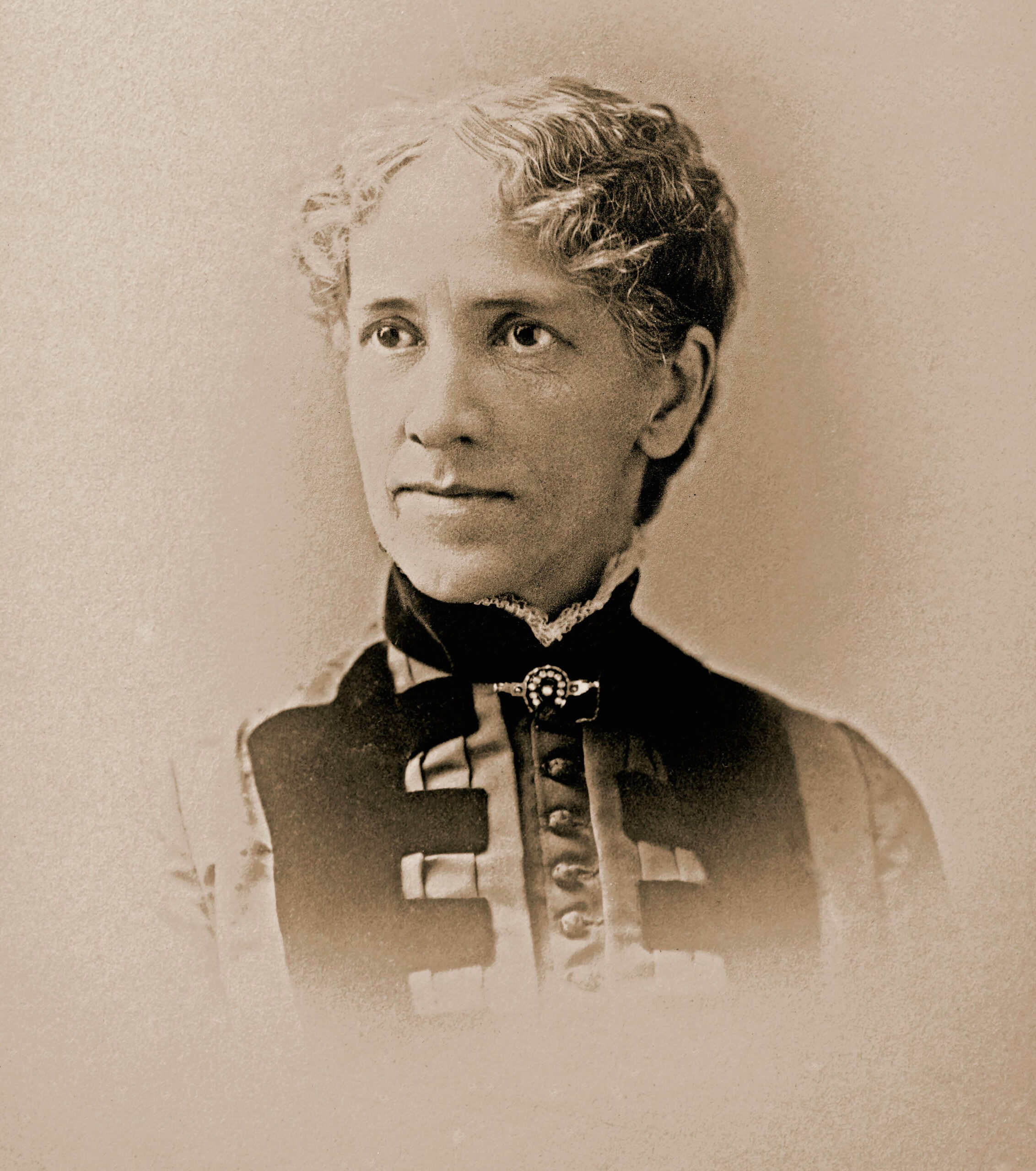 Julia Bartlett portrait. She is wearing a pin at the neck of her dress.