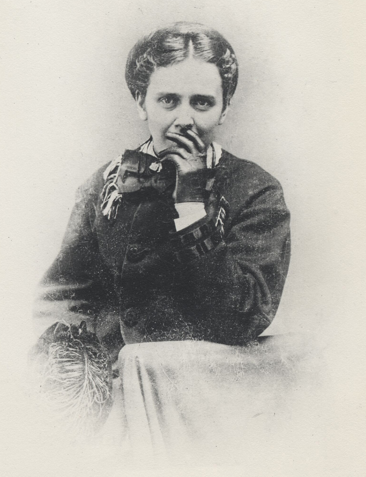 Mary Shipman Dillingham posed for a portrait with a gloved hand lightly covering her mouth.